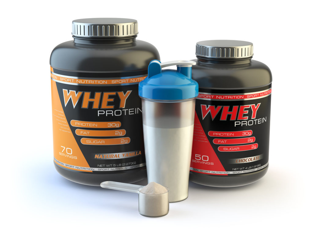 Sport nutrition, whey protein powder for bodybuilding with plastic jars and shaker isolated on white.