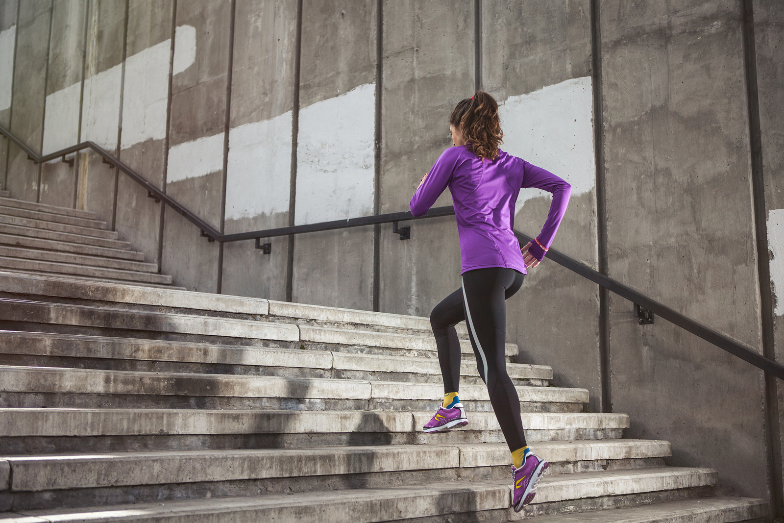 woman running up stairs as part of HIIT workout